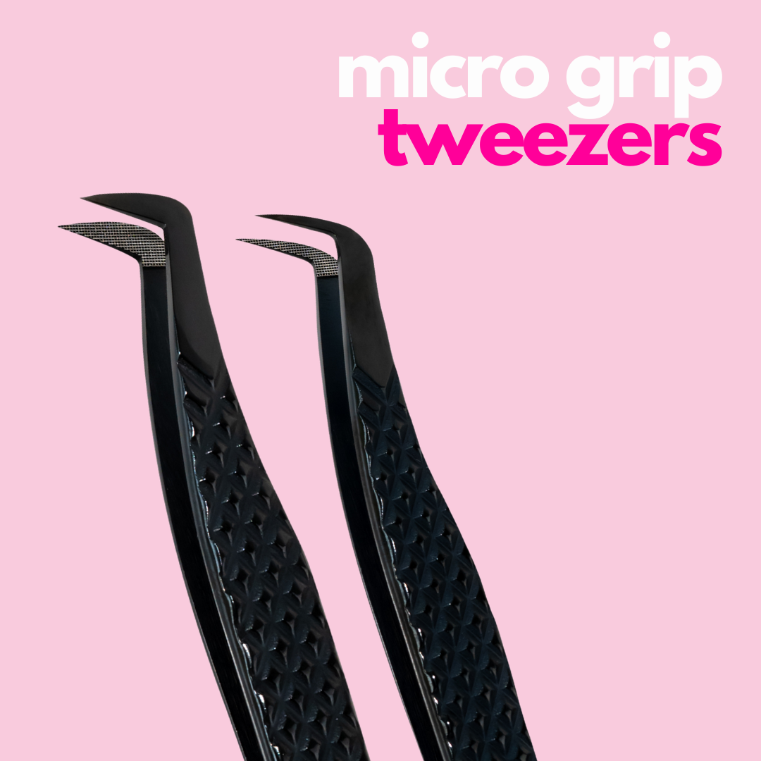Black lash extension tweezers on pink background