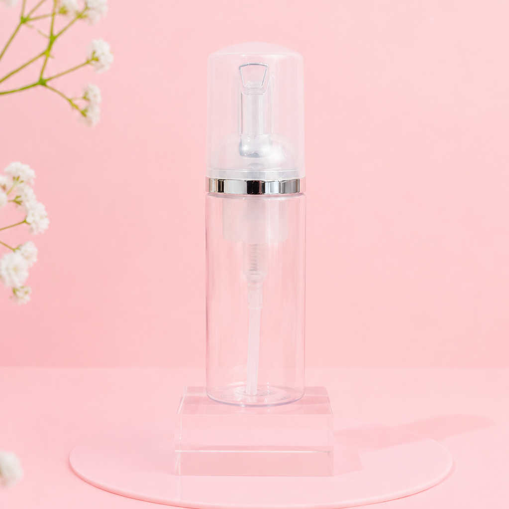 Clear bottle with white cap on a pink background