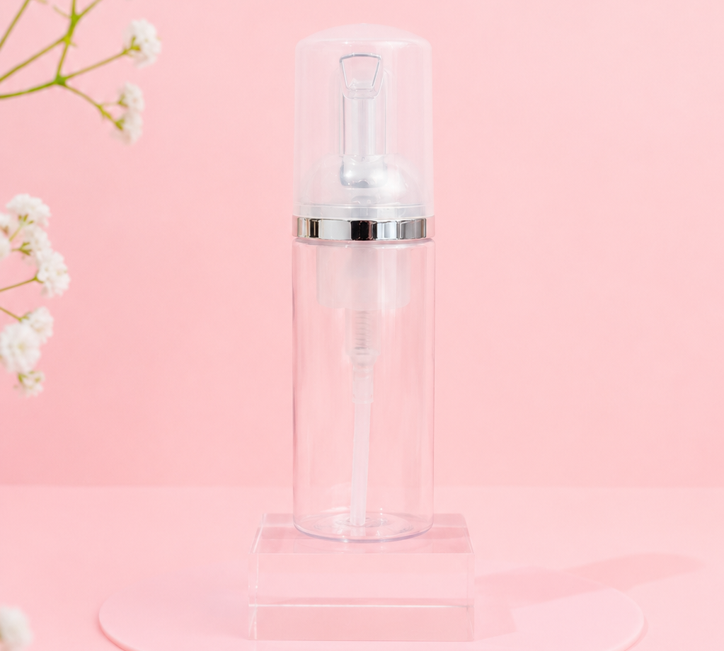 Clear bottle with white cap on a pink background