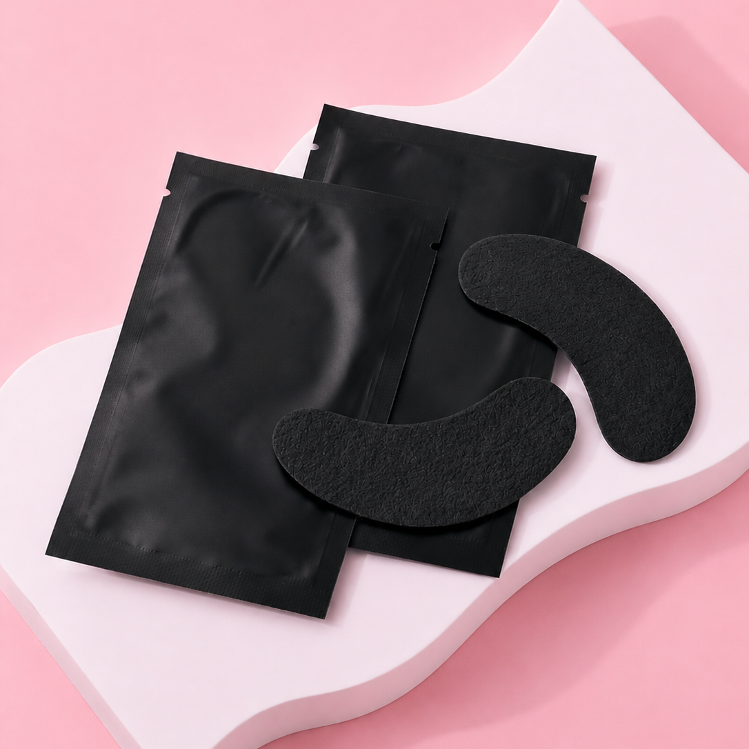 Black eye masks on a pink background