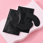 Black eye masks on a pink background