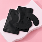 Black eye masks on a pink background