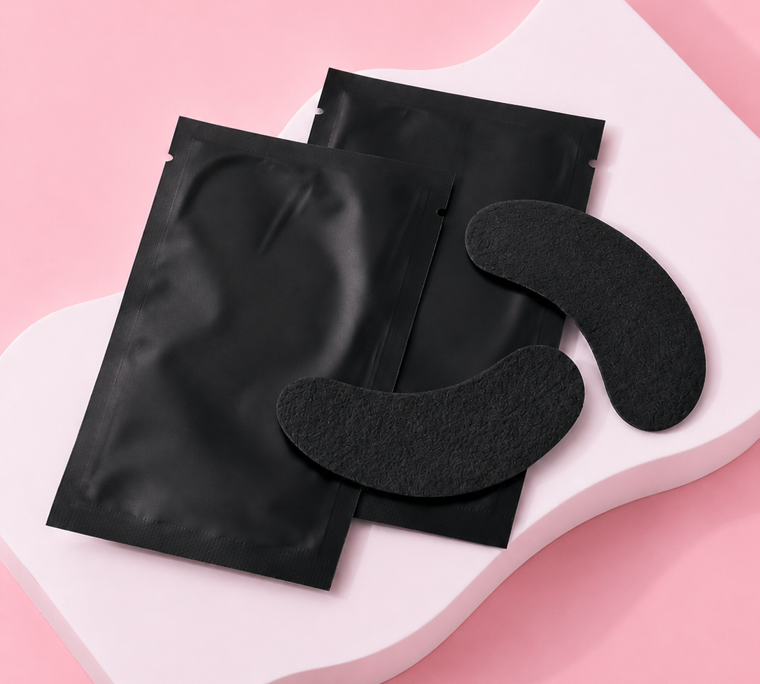 Black eye masks on a pink background