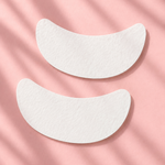 Two white eye patches on a pink background